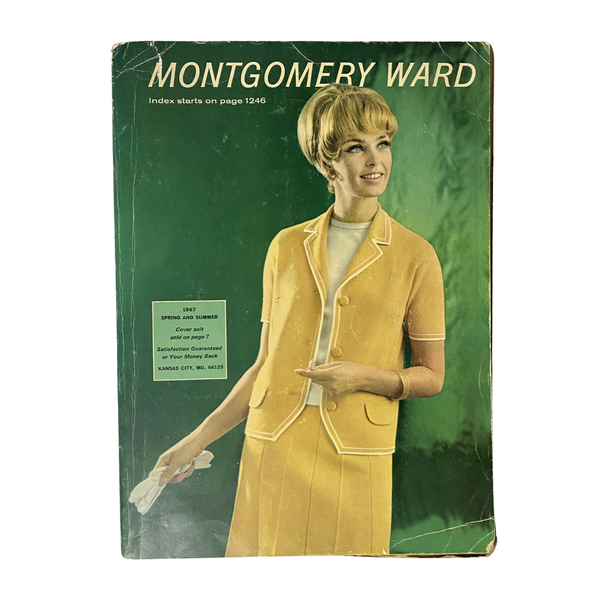 Cover of the 1967 Montgomery Ward Spring and Summer Catalog featuring a stylish woman in a yellow outfit with a jacket and skirt. The catalog showcases 1960s fashion trends and retail history, perfect for vintage fashion enthusiasts.