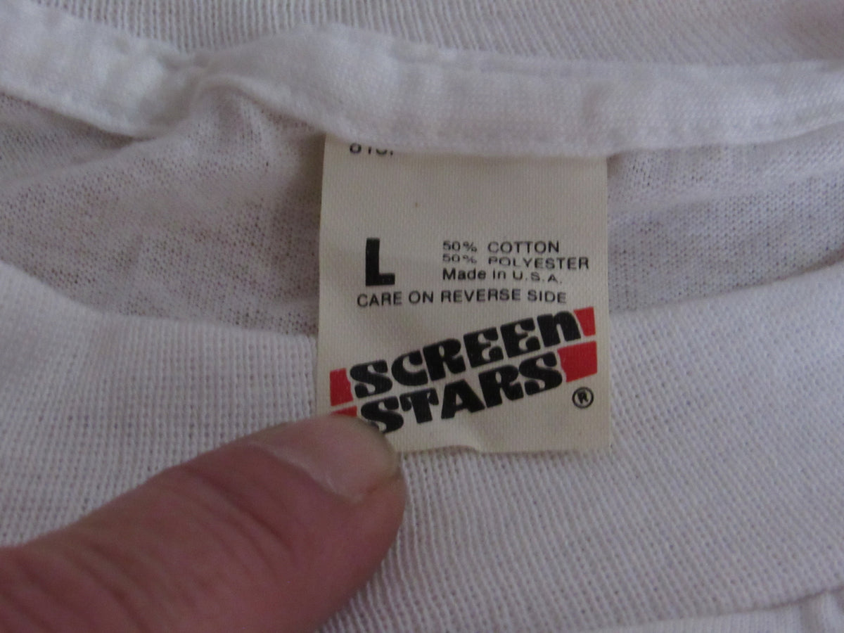 Screen Stars Joker with Batman/U.S Army We're Proud of Them Size L NWOT - Close-up image showing the label of a white t-shirt, indicating size Large, made of 50% cotton and 50% polyester.