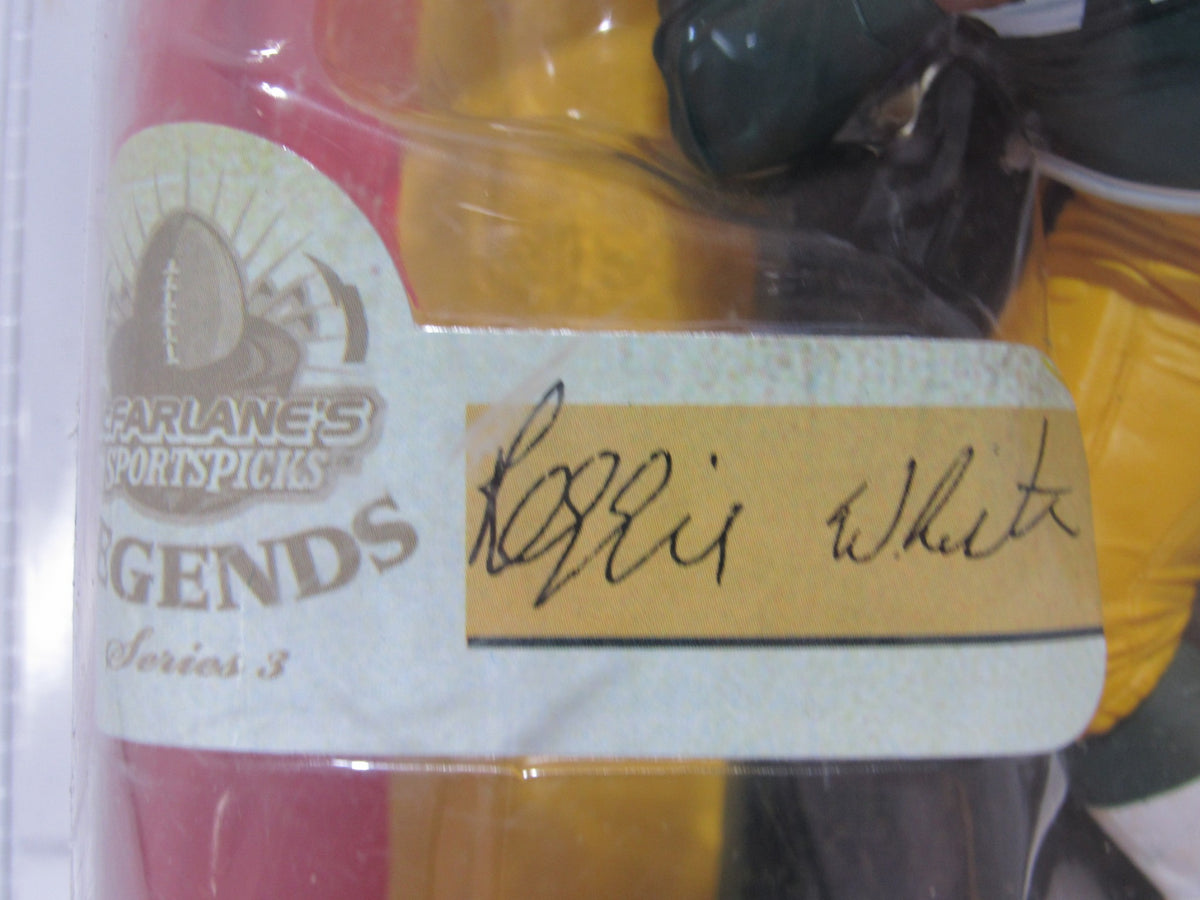 Signature of Reggie White on the packaging of the McFarlane NFL Green Bay Packers Action Figure, highlighting the collectible's authenticity.