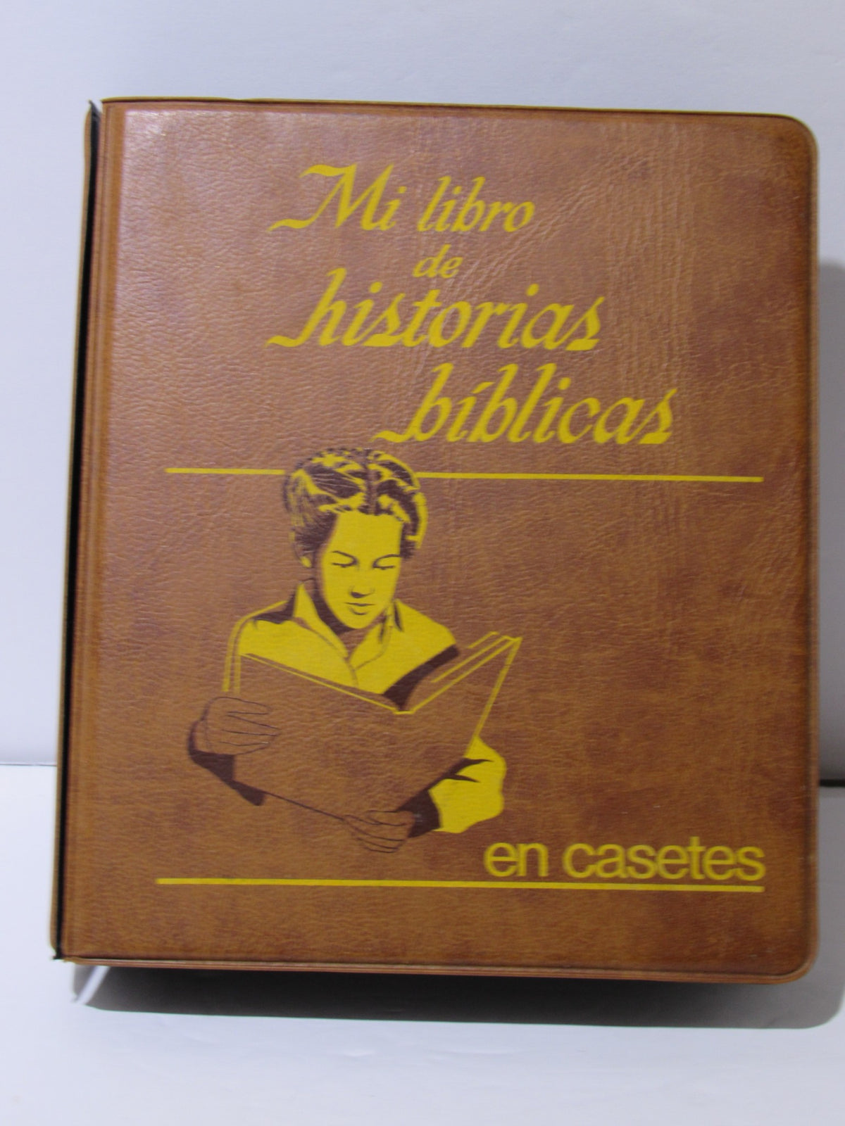 Cover of '1970s Mi Libro de Historias Biblicas My Book of Bible Stories' featuring a child reading with a brown texture.