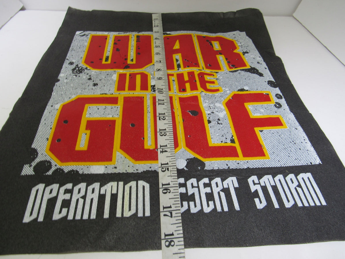 Vintage 90's War in The Gulf: Operation Desert Storm banner presented with a measuring tape alongside, highlighting its vibrant design and historical significance.