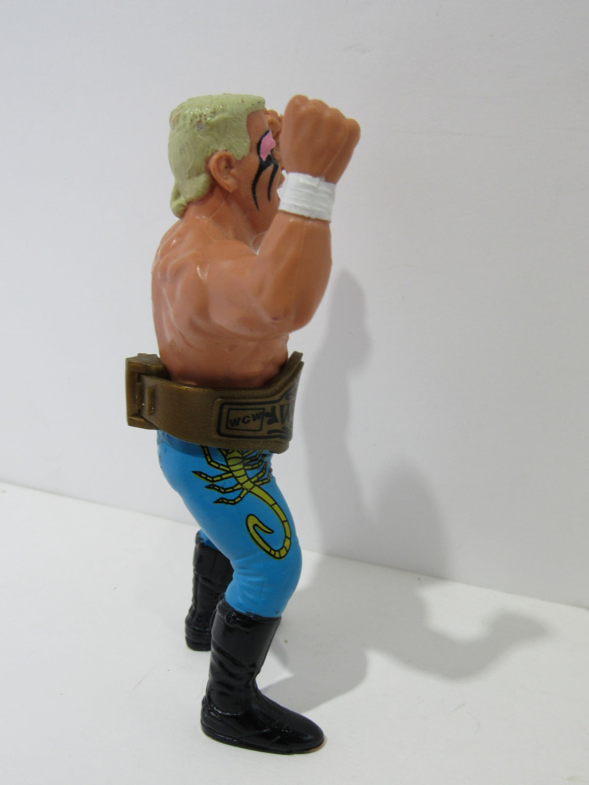 Side profile of the 1990 WCW Galoob Sting with Belt Action Figure, focusing on details of the belt and stance.