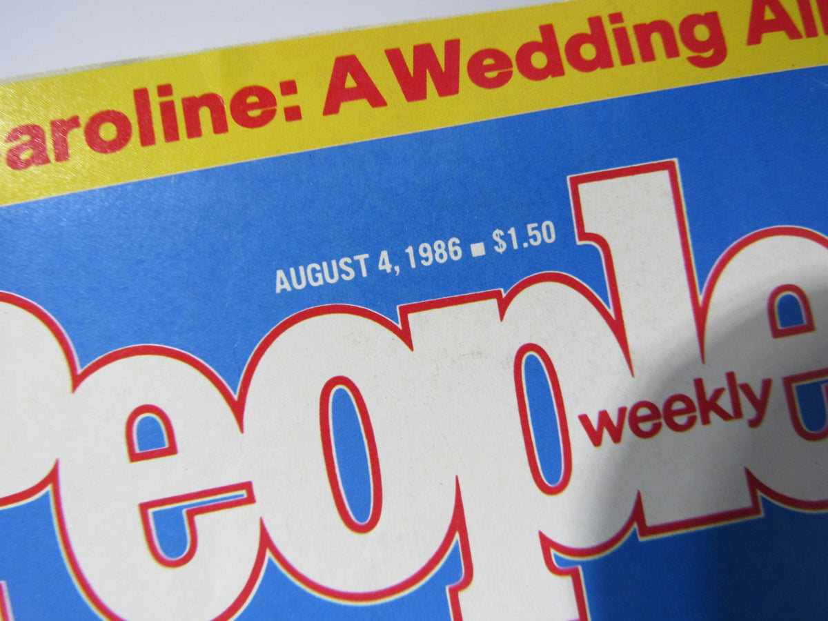 Close-up of the cover of People Weekly Magazine, August 4, 1986, featuring the text 'Caroline: A Wedding All' and highlighting the wedding of Prince Andrew and Sarah Ferguson. The magazine cover showcases a vintage design with vibrant colors and bold typography, making it a collectible item for magazine enthusiasts.