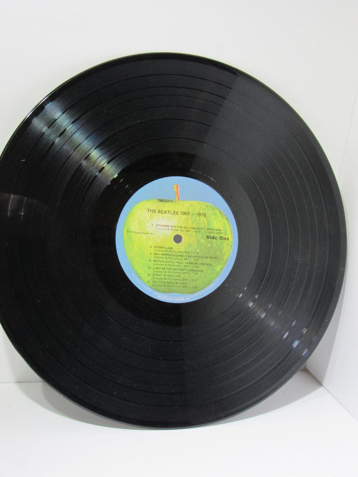 The Beatles 1967-1970 Gatefold Sleeve Vinyl Record - Side One detailing the songs.
