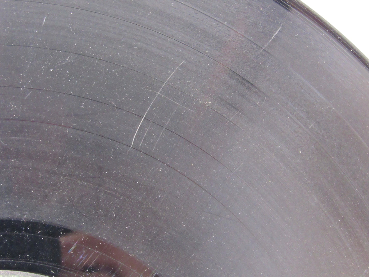 Another close-up image of The Beatles: Abbey Road US Press Apple Records LP SO 383 vinyl showing surface wear and scratches.