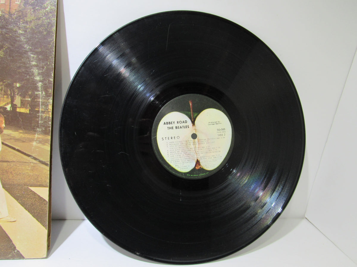 The Beatles: Abbey Road US Press Apple Records LP SO 383 Grade: G+ showing the vinyl record side with notable wear and scratches.