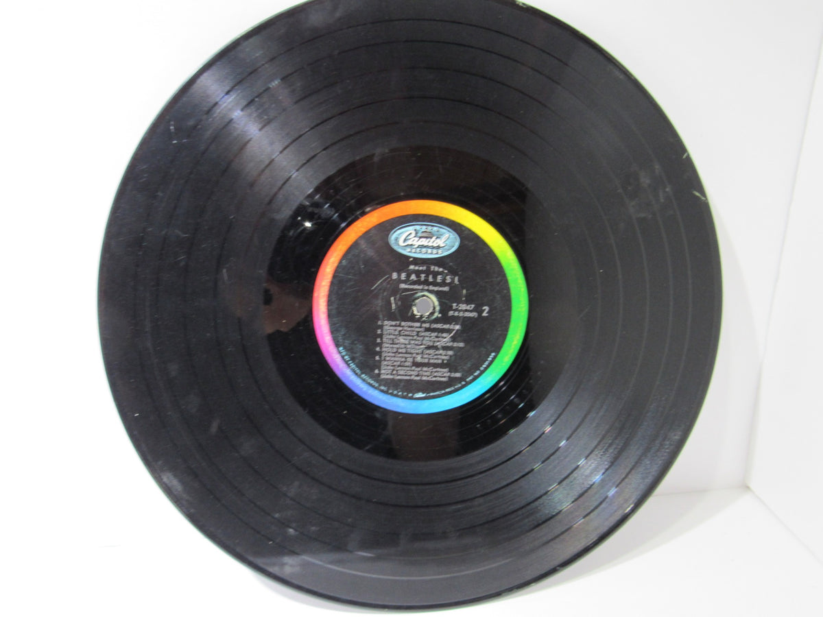 Close-up view of the vinyl record from The Beatles: Meet The Beatles US Mono Capitol Records LP T 2047, showcasing the Capitol label with minor scratches.