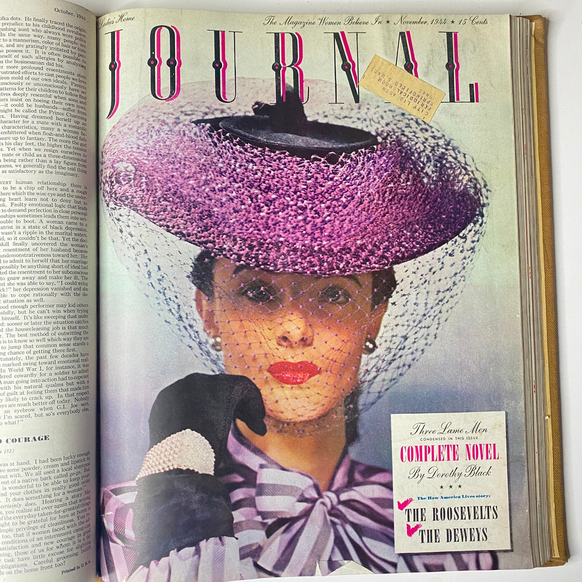 Cover of the Ladies' Home Journal from November 1944 showcasing a woman in a stylish purple hat and gloves, representing 1940s fashion and elegance.