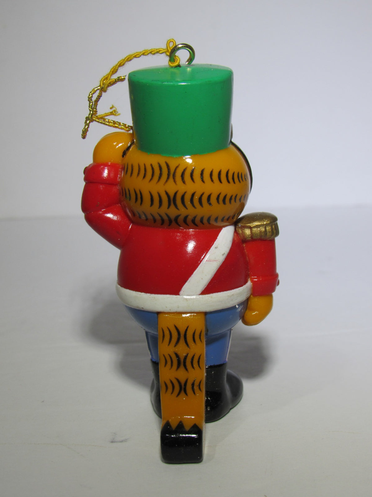 Back view of the 1978 VTG Enesco Treasury of Christmas Ornament depicting Garfield as The Nutcracker, highlighting the detailed uniform and charming tail.