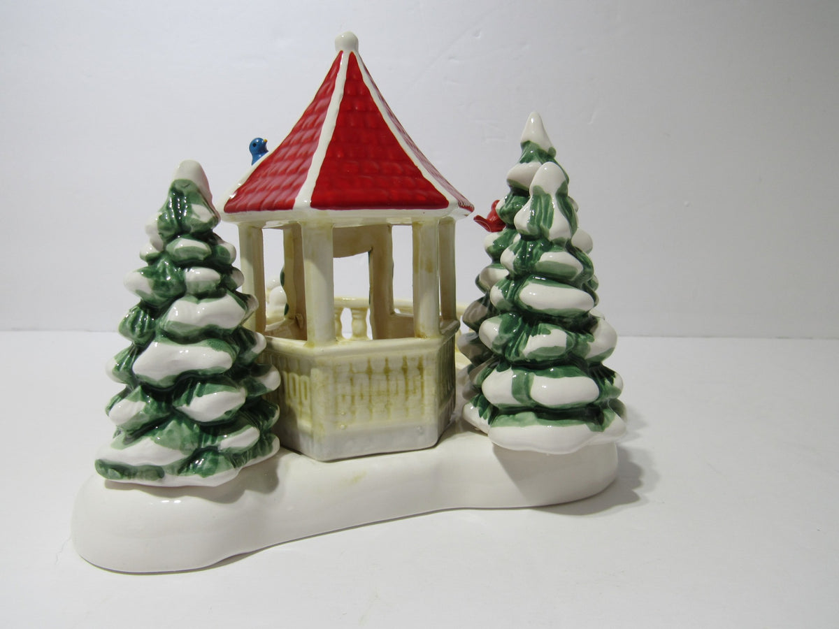 1989 Vintage Department 56 Snow Village Series Village Gazebo with a red roof and snow-covered trees.