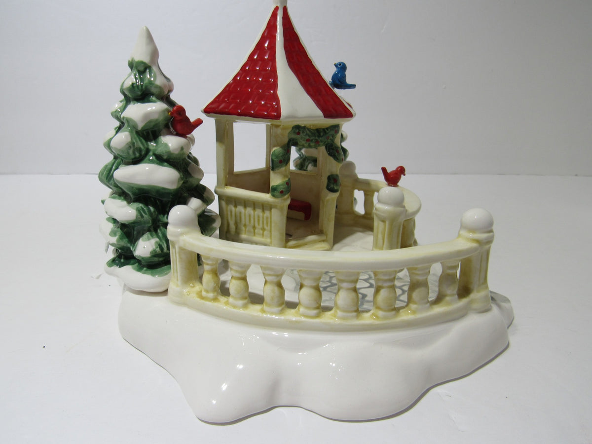 Side view of 1989 Vintage Department 56 Snow Village Series Village Gazebo featuring decorative birds and snow-draped trees.