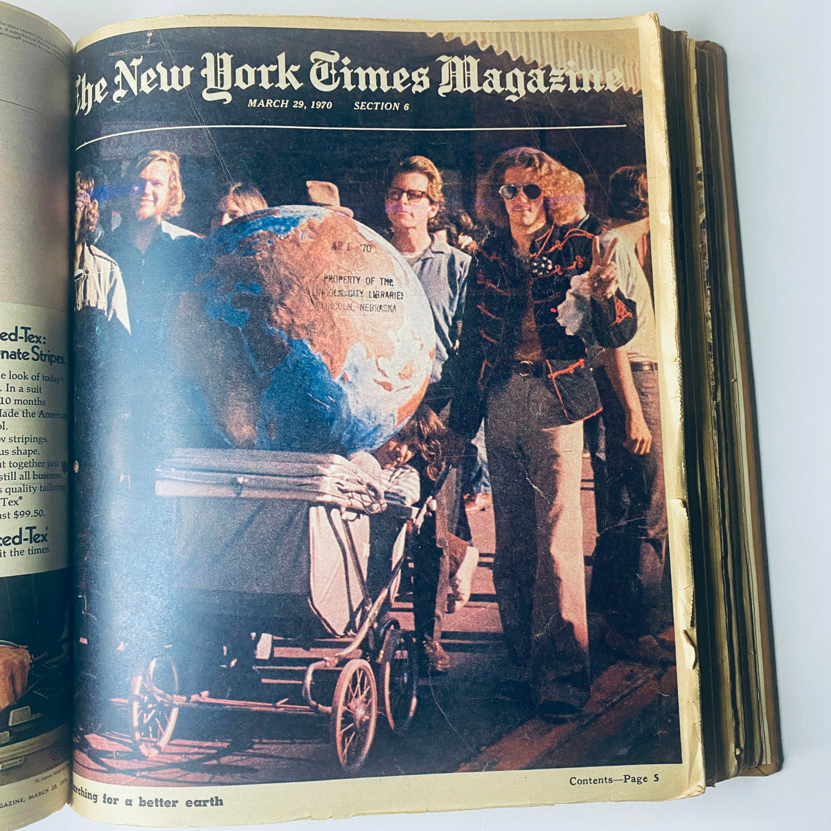 The New York Times Library Edition Bound Magazine - March 29, 1970. Cover features a group of people, including a woman pushing a stroller with a globe, illustrating environmental consciousness.