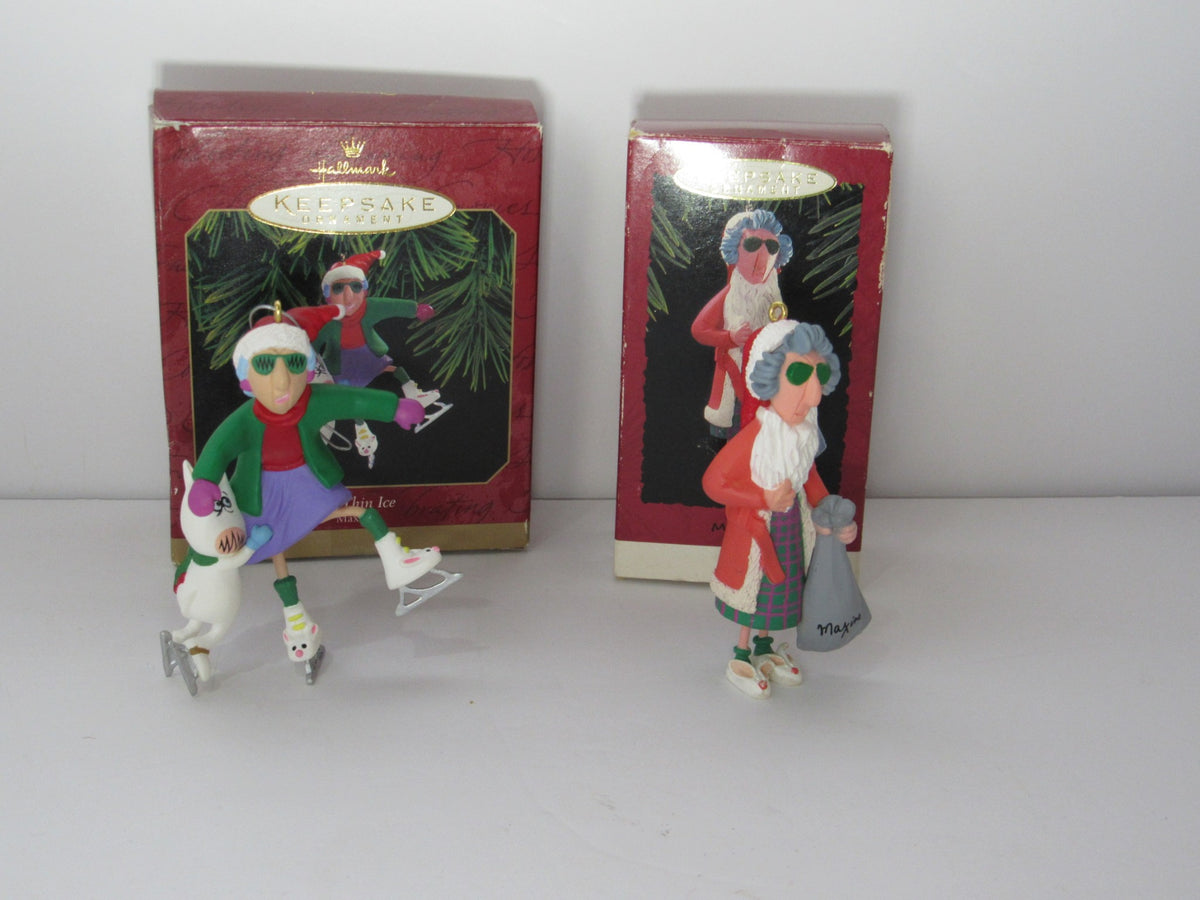 Hallmark Keepsake Ornaments Lot of 2 featuring Maxine on Thin Ice 1999 and Maxine 1993. The image shows the two colorful, whimsical ornaments depicting Maxine ice skating and holding a holiday bag, along with their original boxes.