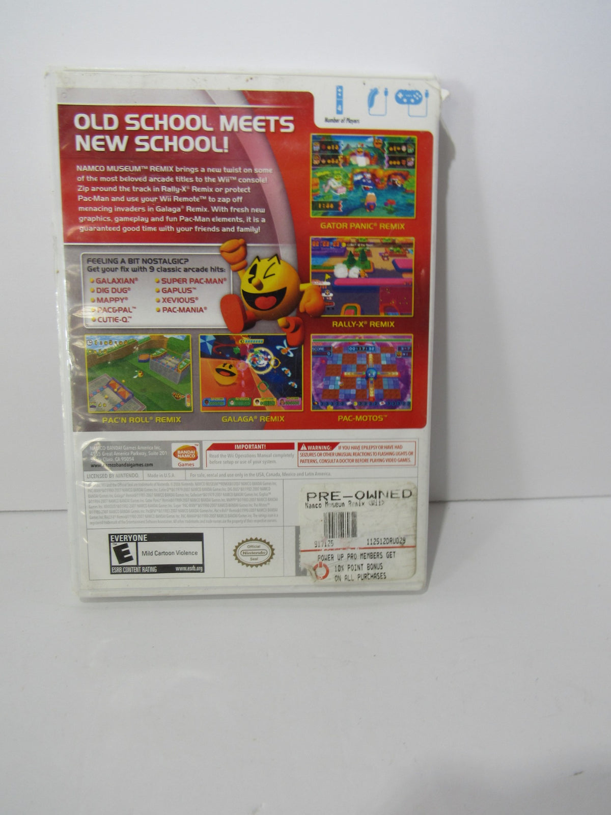 Back cover of 2007 Namco Museum Remix for Nintendo Wii displaying game details and remixed classics, including Pac-Man and Galaga.