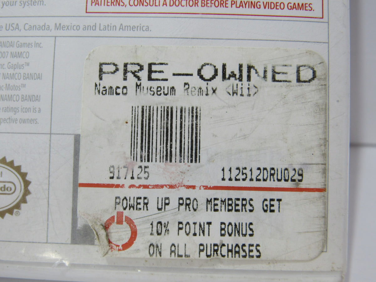Back cover of the 2007 Namco Museum Remix Nintendo Wii game case, featuring pre-owned sticker and details regarding ownership.