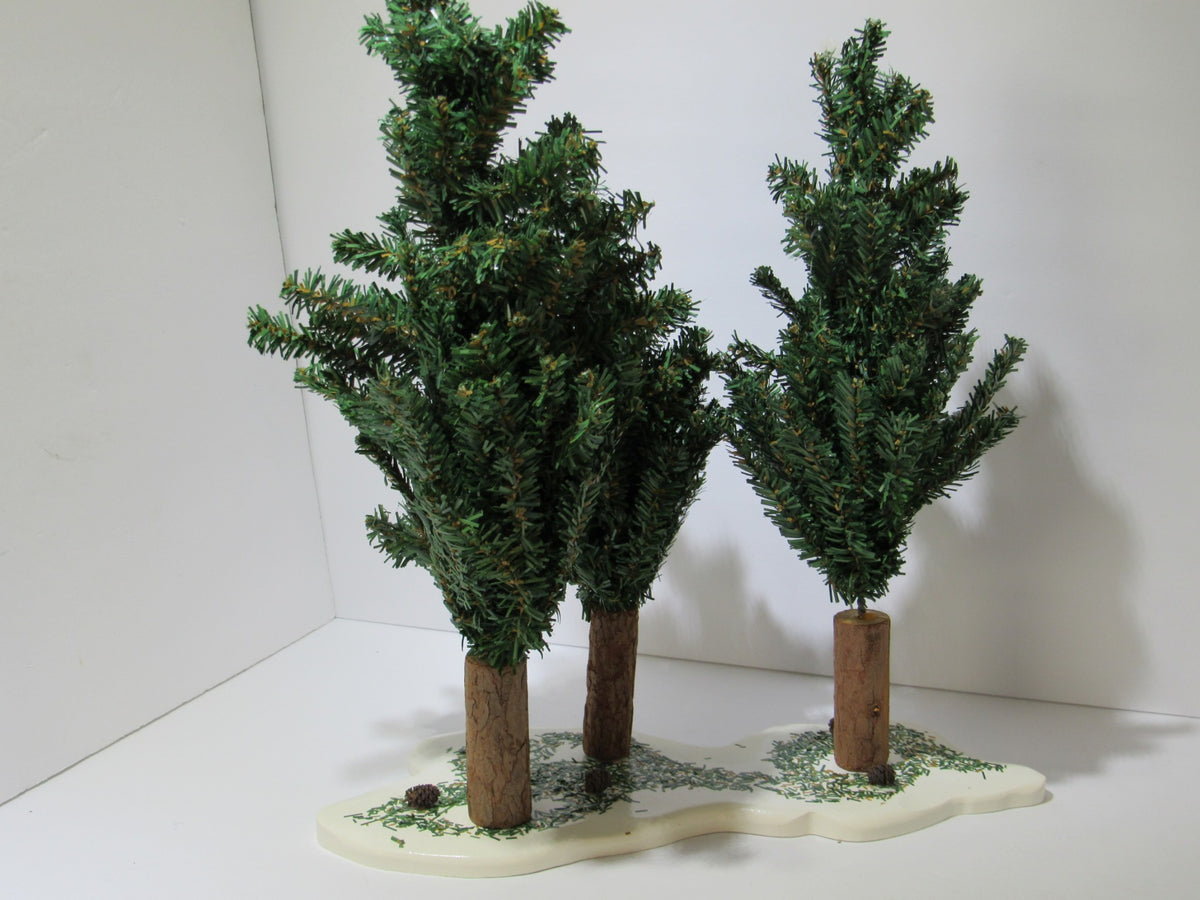 Vintage Department 56 Village Spruce Tree Forest with Wooden Base #5248-5 featuring three lush green trees on a snowy base.