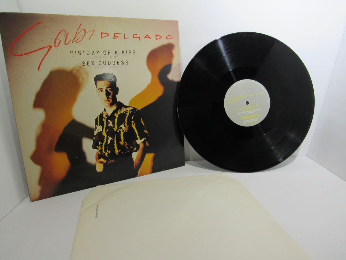 Gabi Delgado: History Of A Kiss Virgin VS 579-12 LP featuring a photograph of Gabi Delgado beside the vinyl record, showcasing the album cover design.