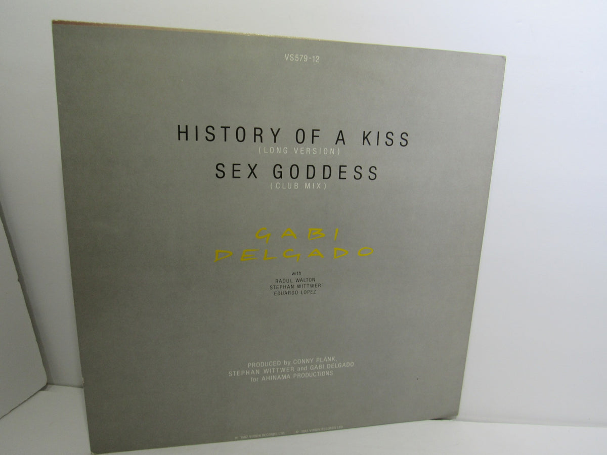 Back cover of the Gabi Delgado: History Of A Kiss album, showcasing track titles and production credits against a minimalist gray background.