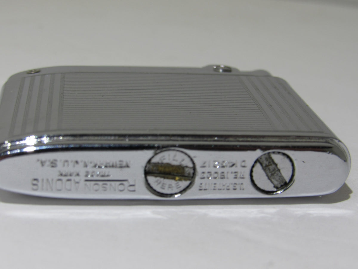 Underside view of Vintage Ronson Adonis Chrome Striped Lighter #145217 featuring the brand name and details.