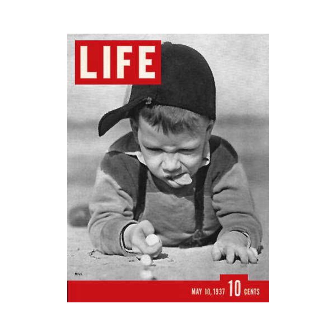 Cover of VTG Life Magazine May 10, 1937 featuring a child intently playing marbles in a sandbox, showcasing the playful spirit of youth.
