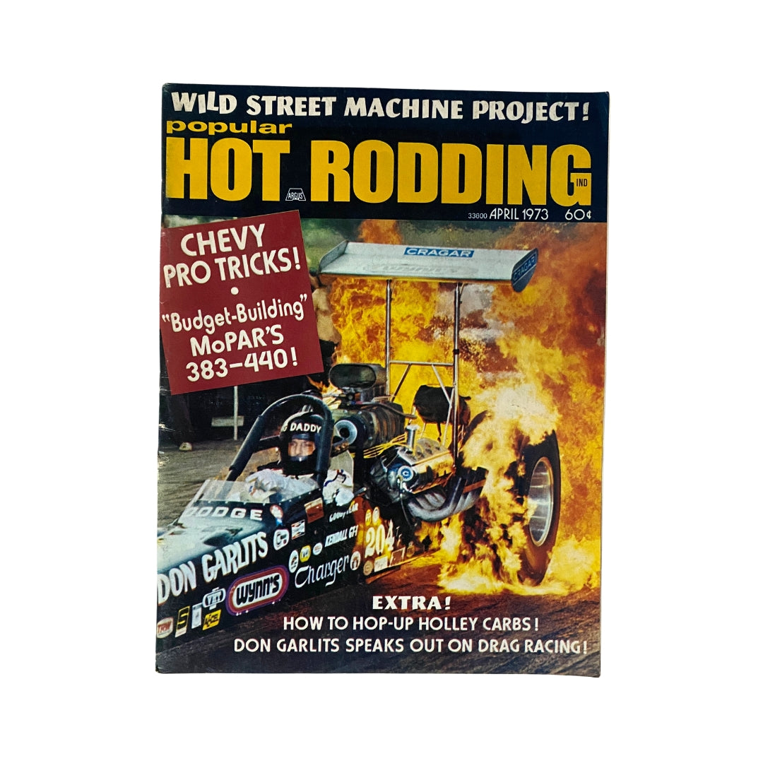 Cover of Popular Hot Rodding Magazine April 1973 featuring the Wild Street Machine project, showcasing a dragster amidst flames with key highlights like Chevy Pro Tricks.