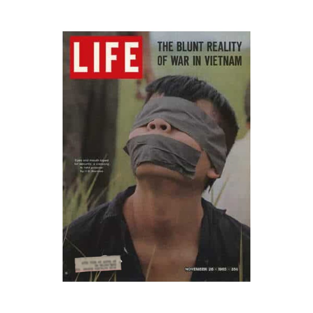 Vintage Life Magazine cover dated November 26, 1965, featuring the title 'THE BLUNT REALITY OF WAR IN VIETNAM'. The cover shows a Vietnamese prisoner with blindfolds and tape over his mouth, illustrating the harsh realities of the Vietnam War and offering a historical perspective on wartime experiences.