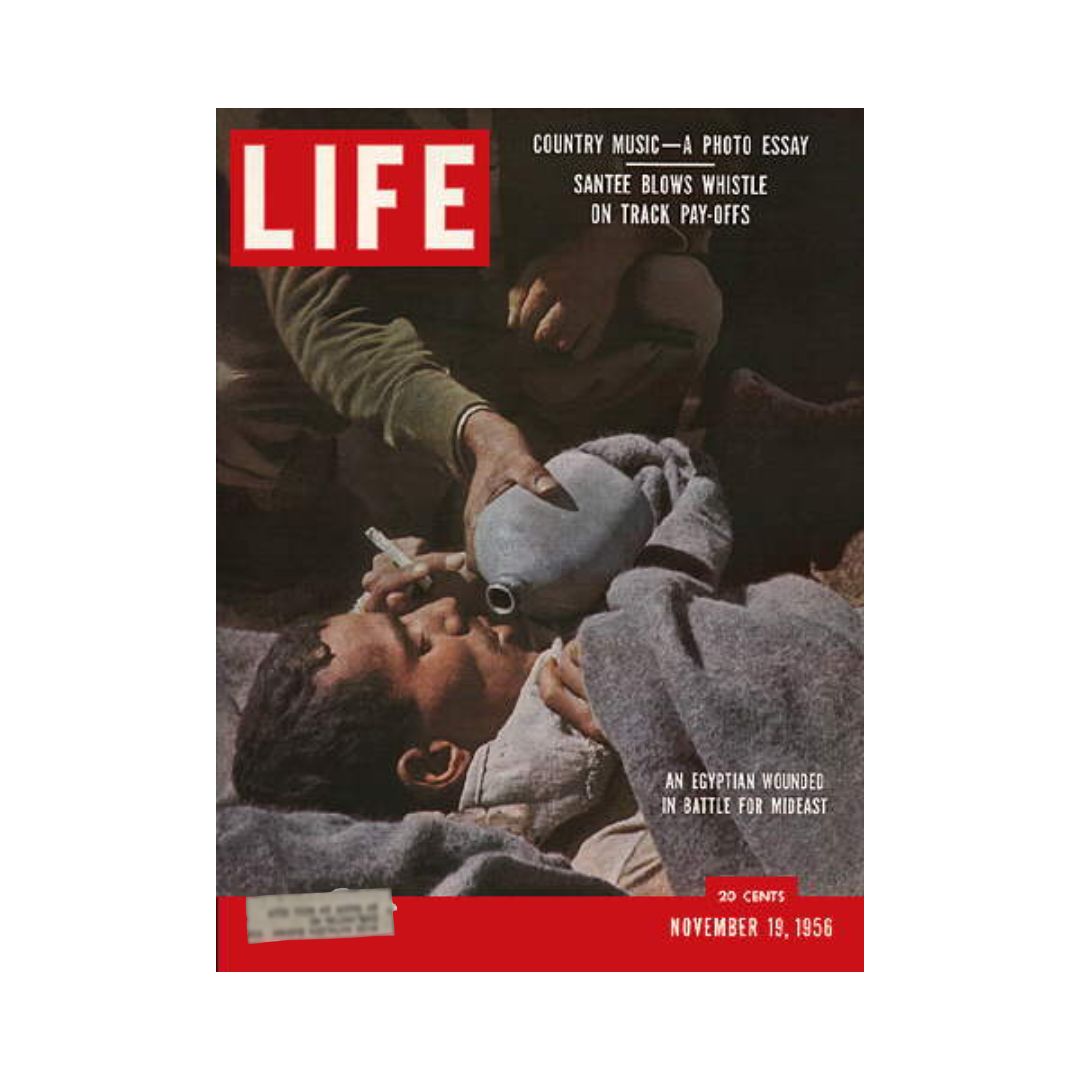 Cover of VTG Life Magazine from November 19, 1956, featuring a poignant image of an Egyptian wounded in battle during the Middle East conflict, highlighting the cover story 'Egypt Battles for the Middle East'.