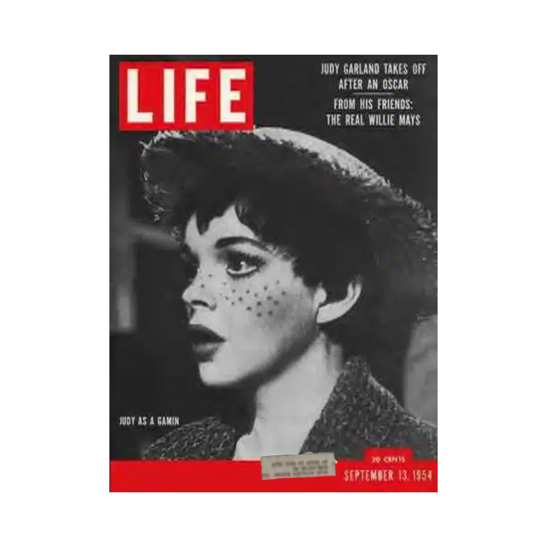 Cover of VTG Life Magazine from September 13, 1954, featuring Judy Garland with a striking expression and artistic makeup. The magazine highlights Judy Garland's achievements and includes headlines about her Oscar win and Willie Mays.