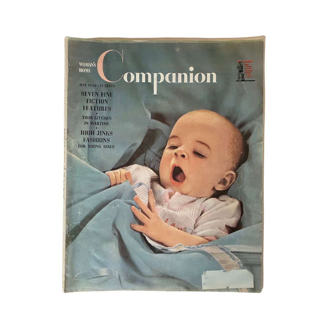 Cover of Woman's Home Companion Magazine May 1942 featuring a baby yawning and highlighting seven fine fiction features.