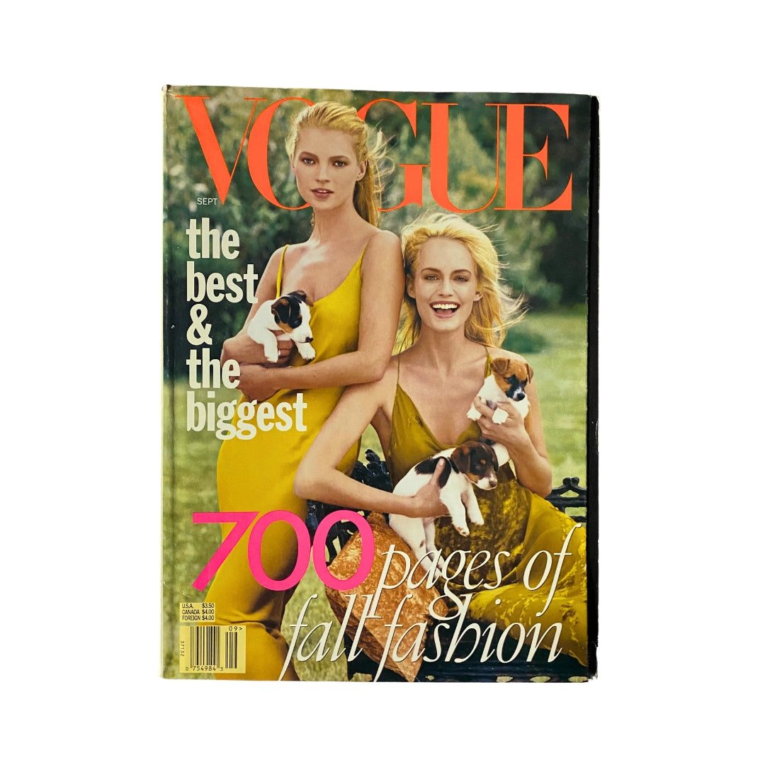 Cover of Vogue Magazine September 1996 featuring Kate Moss and Amber Valletta, showcasing vibrant yellow dresses while holding puppies, highlighting '700 pages of fall fashion'.
