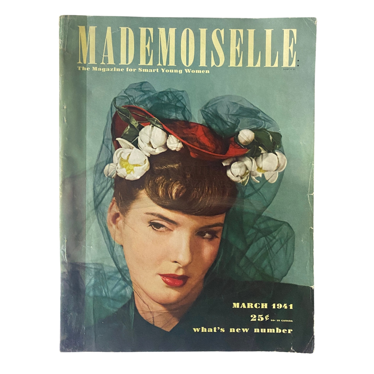 Cover of Mademoiselle Magazine March 1941 What's New Number featuring a woman with a stylish hat adorned with flowers and a vintage aesthetic, showcasing early 1940s fashion.