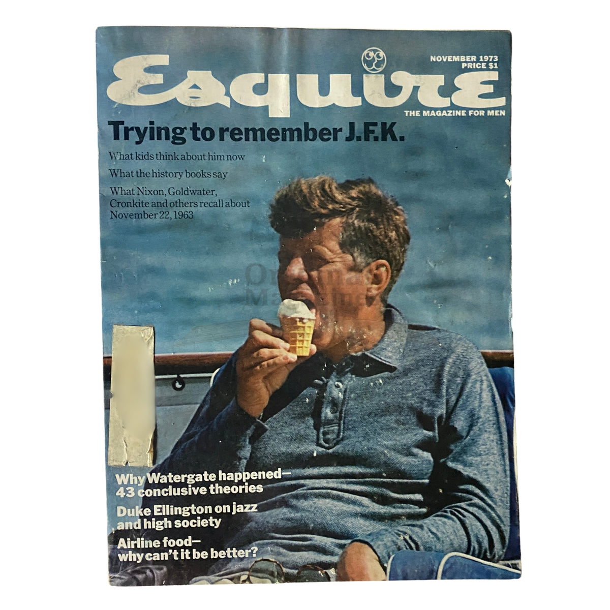 Cover of Esquire Magazine November 1973, featuring the title 'Trying to remember J.F.K.' The image depicts a man sitting outdoors, enjoying ice cream, with headlines about Watergate and Duke Ellington.