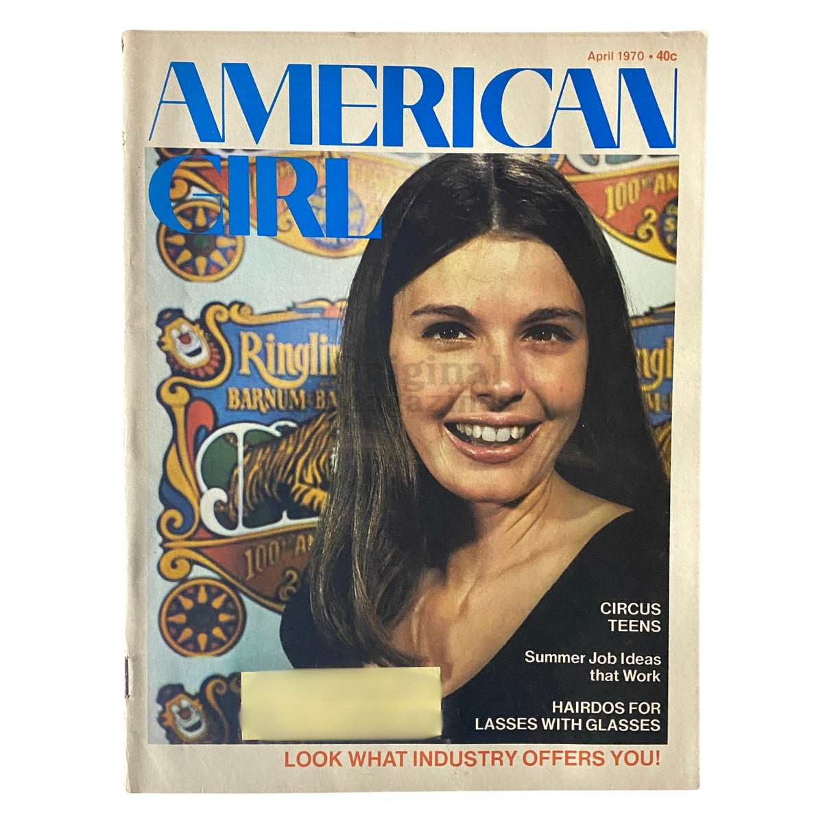 Cover of the April 1970 issue of American Girl Magazine featuring the title 'American Girl' prominently displayed. The magazine showcases a smiling young girl with long hair and glasses, accompanied by illustrations related to circus themes and highlighted topics such as 'Hairdos for Lasses with Glasses.' This vintage magazine is a collectible piece reflecting the fashion and culture of its time.