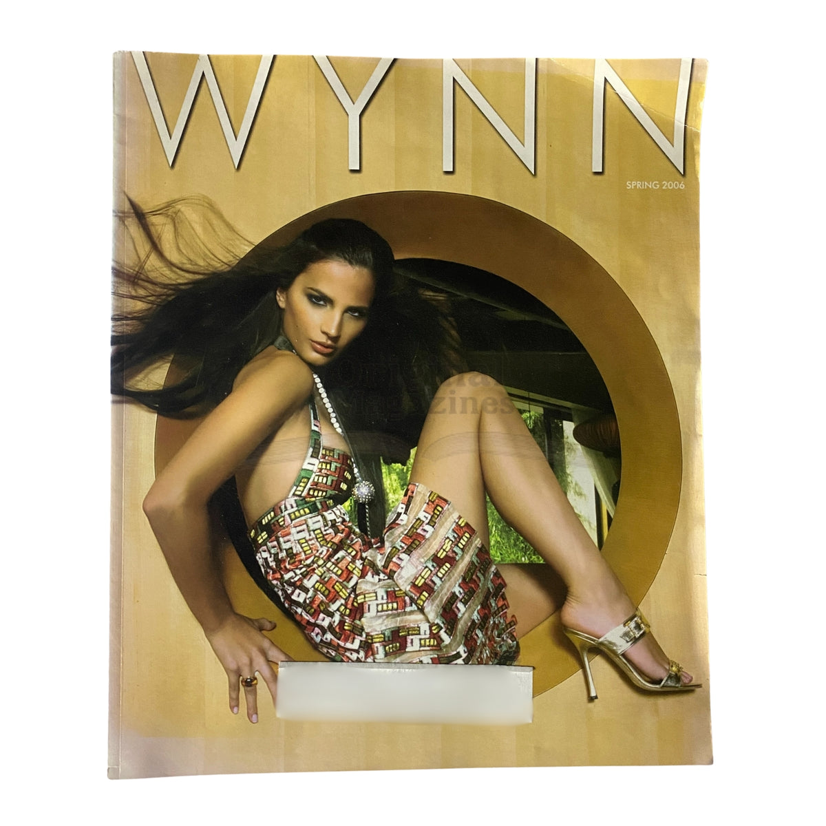 Wynn Magazine Spring 2006 cover featuring a model in a colorful fashion dress, showcasing vintage style and design.