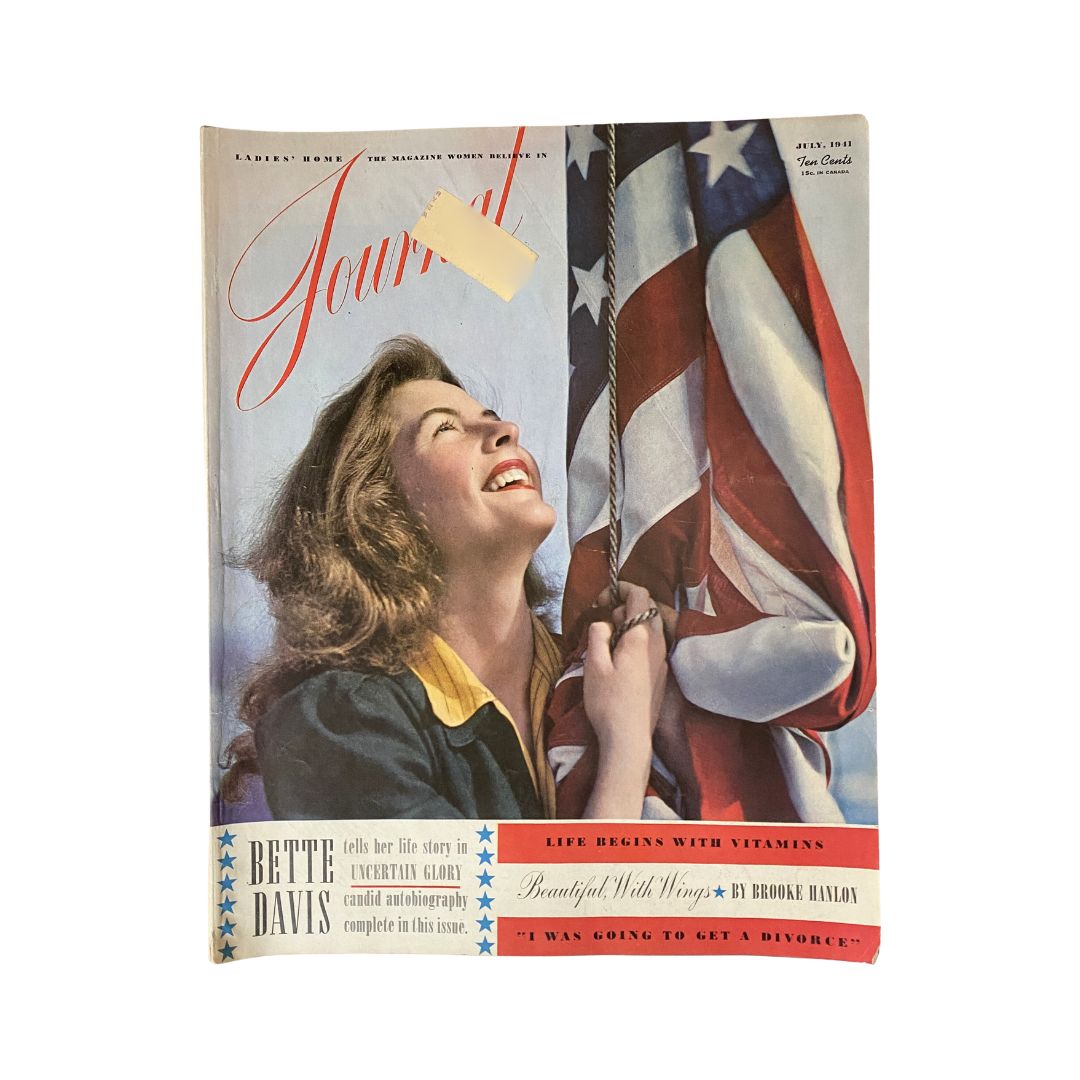 Cover of July 1941 Ladies' Home Journal Magazine featuring Bette Davis, showcasing her exuberant smile against an American flag backdrop, indicating the era's cultural aesthetics.