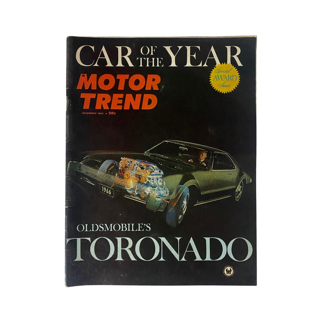 Vintage Motor Trend Magazine cover from December 1965 featuring Oldsmobile Toronado, showcasing the 'Car of the Year' award with a sleek automotive design.