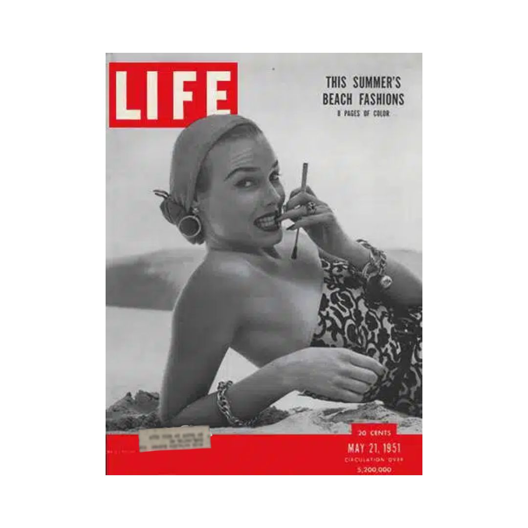 VTG Life Magazine May 21, 1951 featuring beach fashion cover with a model posing elegantly in a swimsuit, showcasing summer styles of the early 1950s. The magazine highlights the vibrant cultural moments with a striking monochrome aesthetic and bold red header.