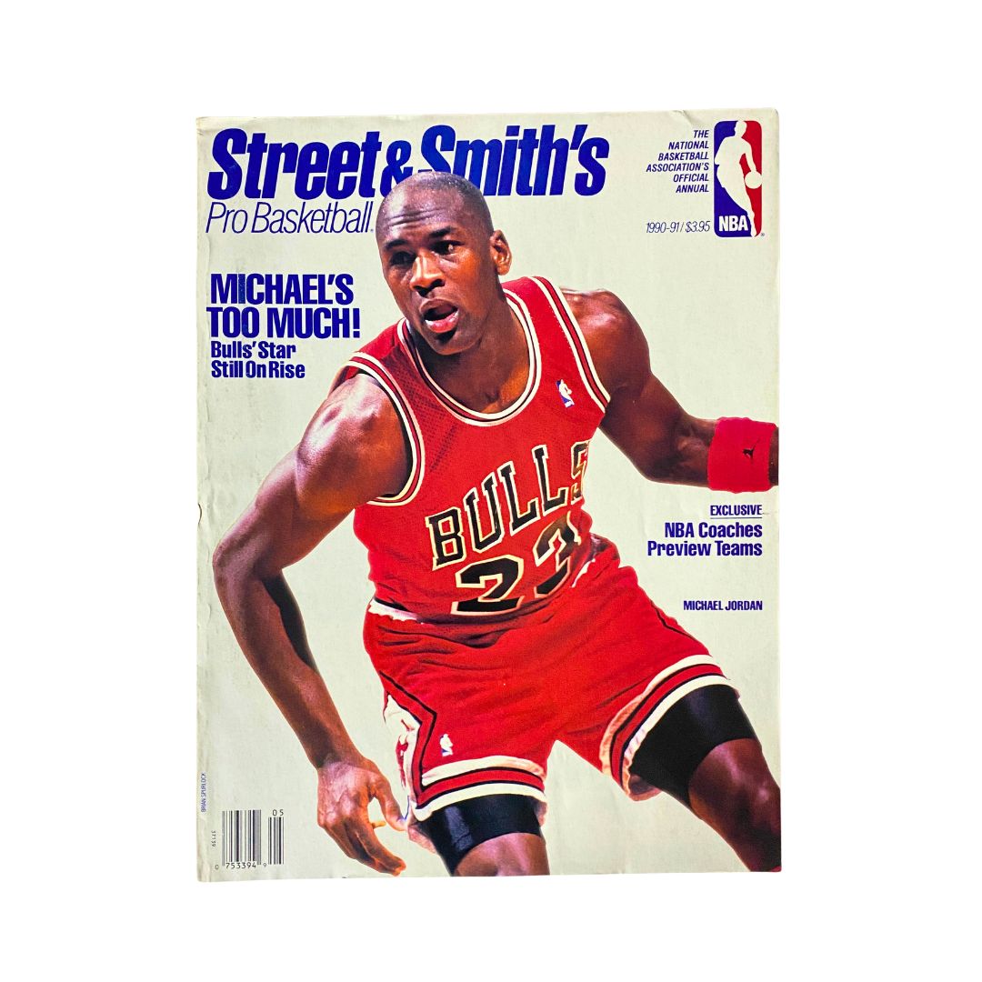 Cover of Street & Smith's Pro Basketball 1990-1991 magazine featuring Michael Jordan in a red Chicago Bulls uniform, highlighting the headline 'Michael's Too Much!' and showcasing the prominent NBA logo.