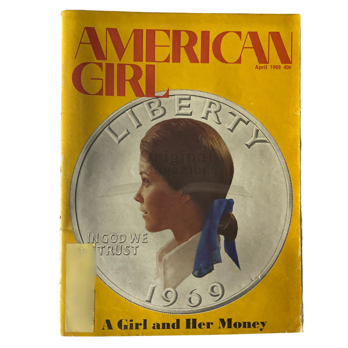 Cover of American Girl Magazine April 1969 titled 'A Girl and Her Money', featuring a profile of a girl with a blue ribbon in her hair overlaid on a large silver coin with the year 1969.