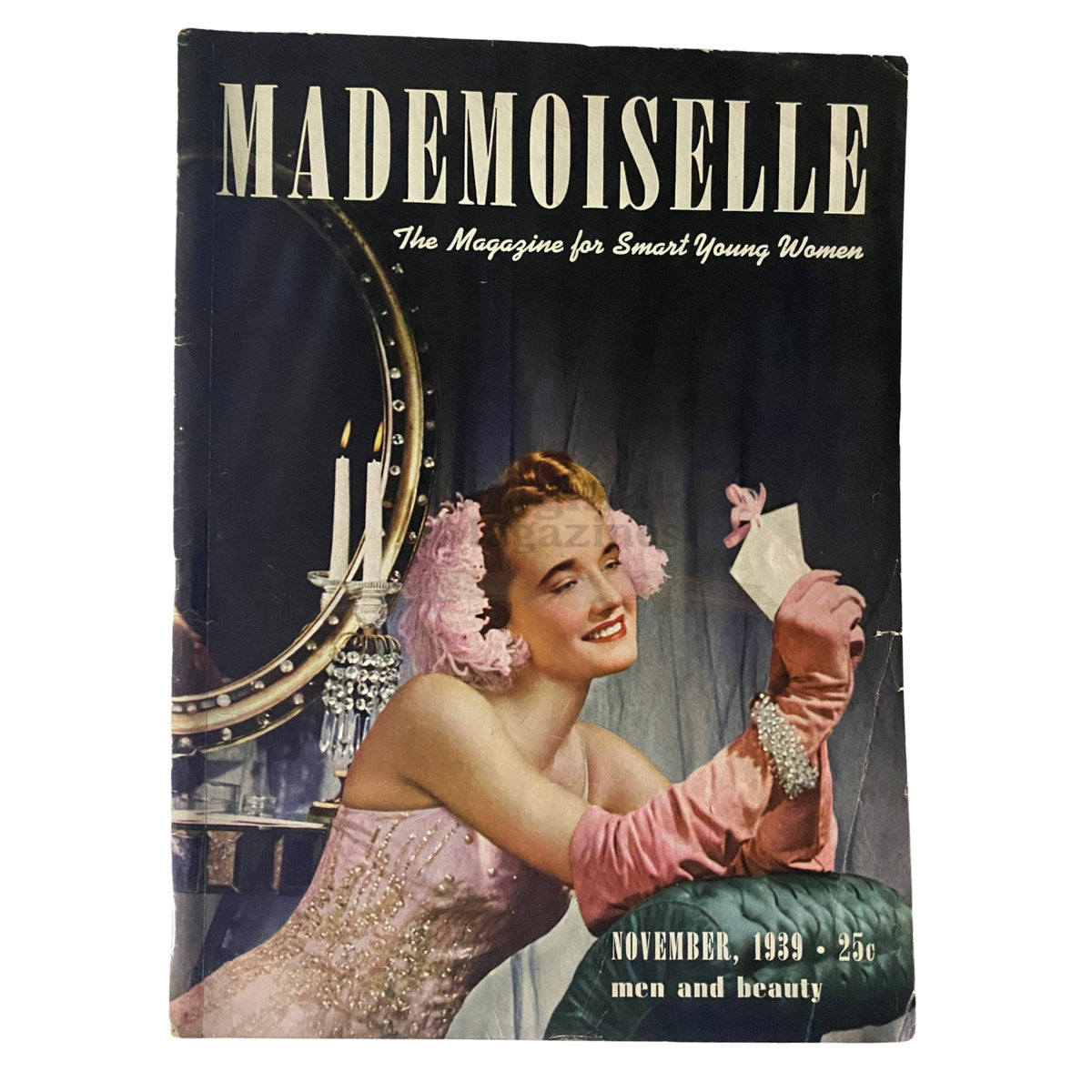 Cover of Mademoiselle Magazine November 1939 featuring an elegant woman dressed in a glamorous gown, surrounded by a mirror and candles, highlighting the theme of 'Men and Beauty'.