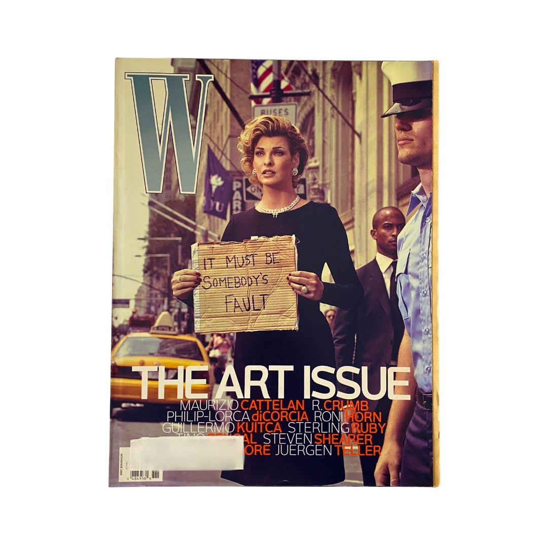 W Magazine November 2009 cover featuring Linda Evangelista, highlighting the Art Issue. The cover portrays a stylish model holding a sign in a busy urban street.
