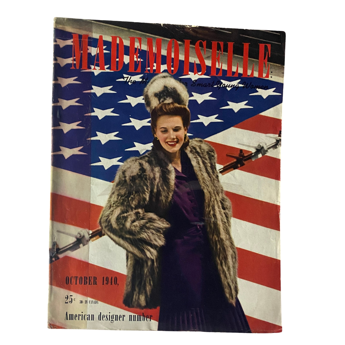 Mademoiselle Magazine October 1940 cover featuring a woman in a fur coat against a backdrop of the American flag, showcasing vintage American design.