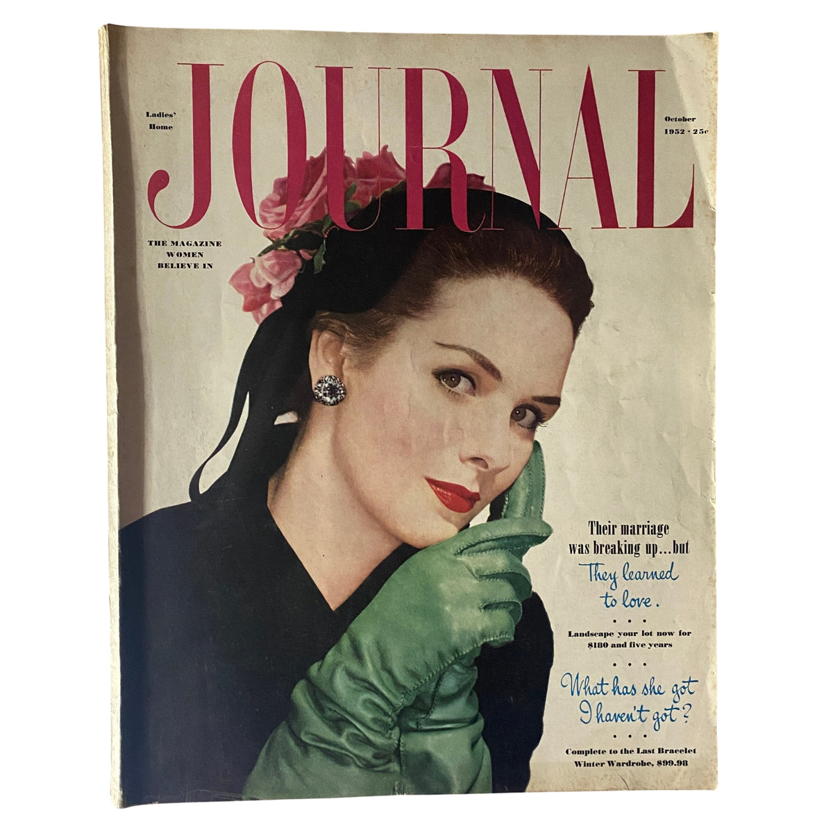 Cover of October 1952 edition of Ladies' Home Journal featuring a woman with a floral headpiece and green gloves, showcasing mid-century fashion and design.
