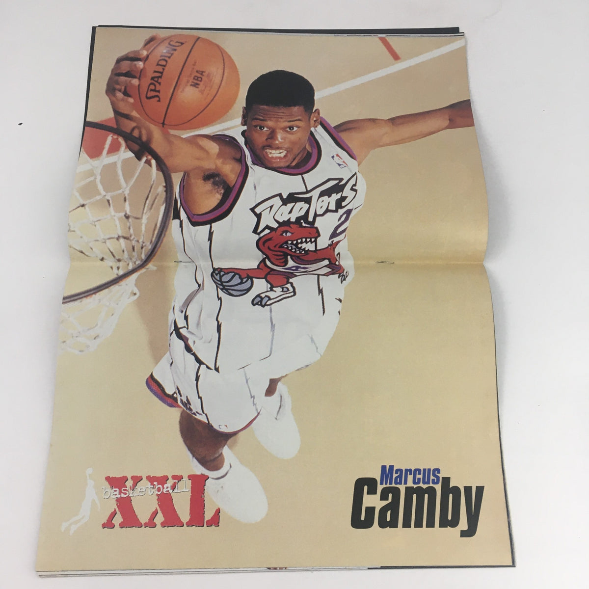 Inside spread of XXL Basketball Magazine February 1999 showcasing Marcus Camby in action, emphasizing the magazine's feature on notable players.