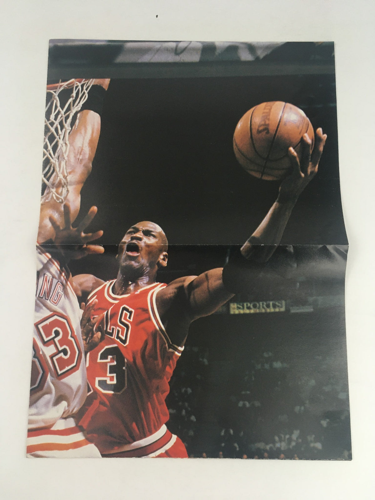 Postcard-sized image from XXL Basketball Magazine February 1999 depicting Michael Jordan performing a dramatic play, showcasing his athleticism.