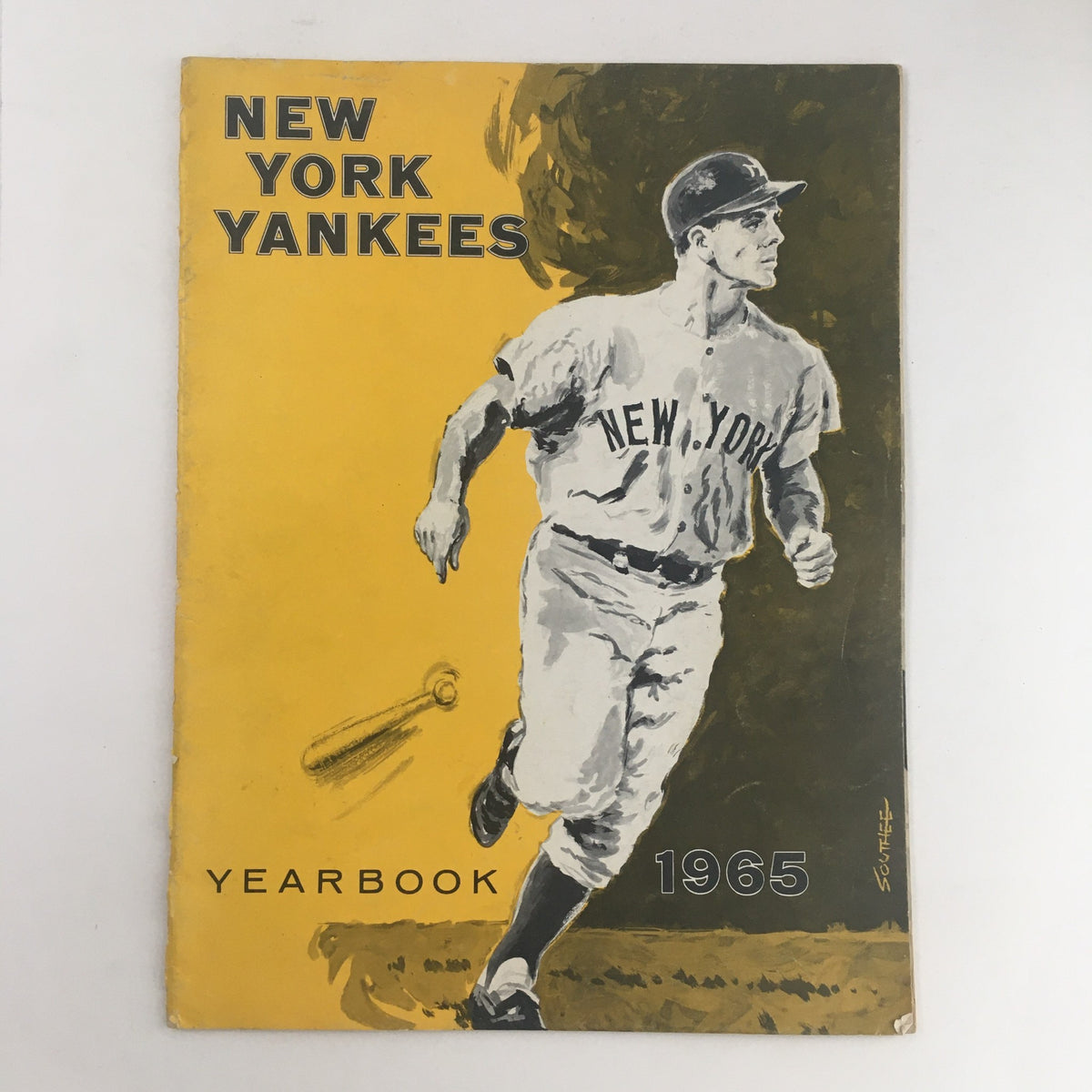 1965 New York Yankees Official Yearbook cover featuring a player in action, showcasing team colors and graphics, ideal for baseball memorabilia collectors.