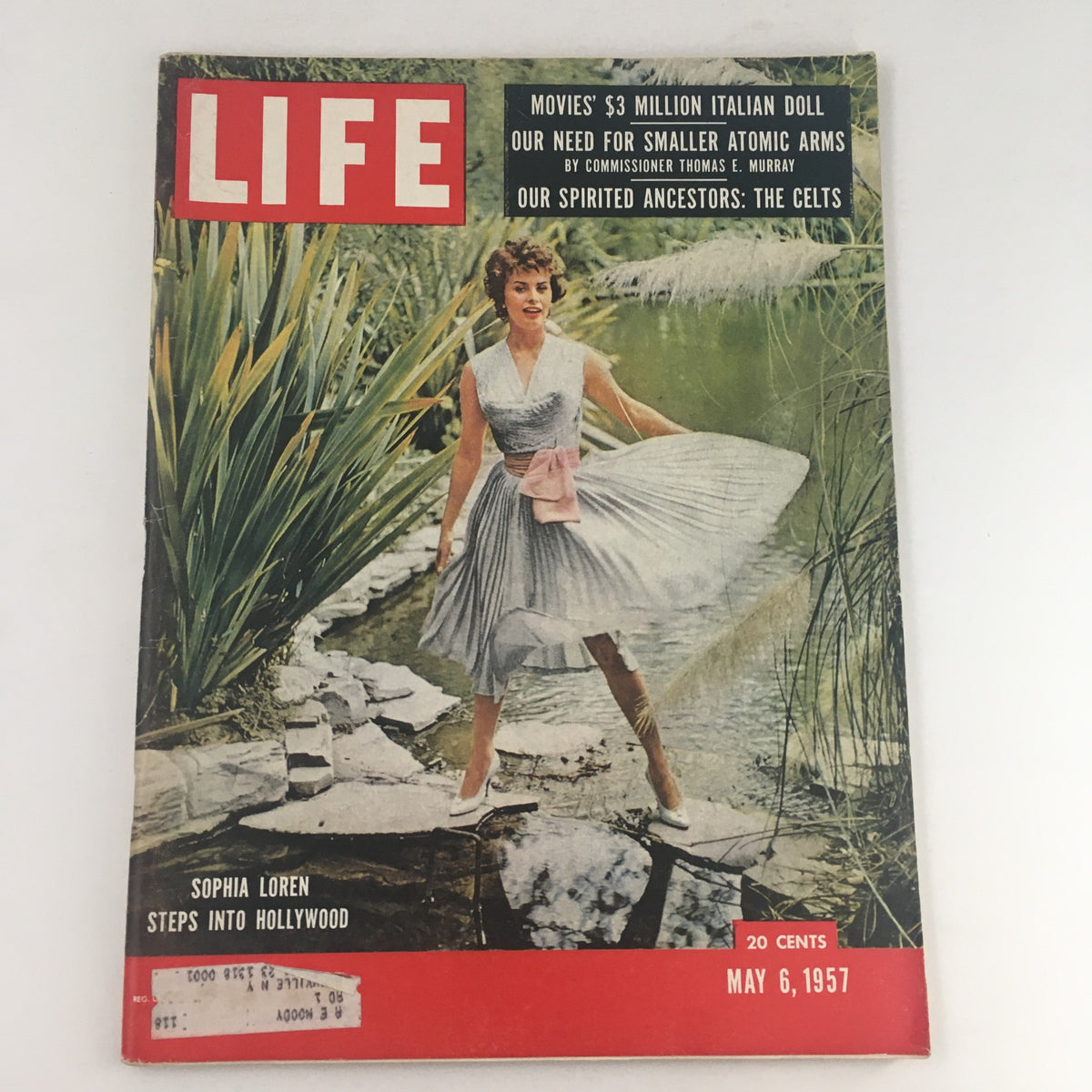 Life Magazine May 6 1957 featuring actress Sophia Loren on the cover, elegantly dressed in a flowing gown, standing beside a serene pond surrounded by lush greenery.