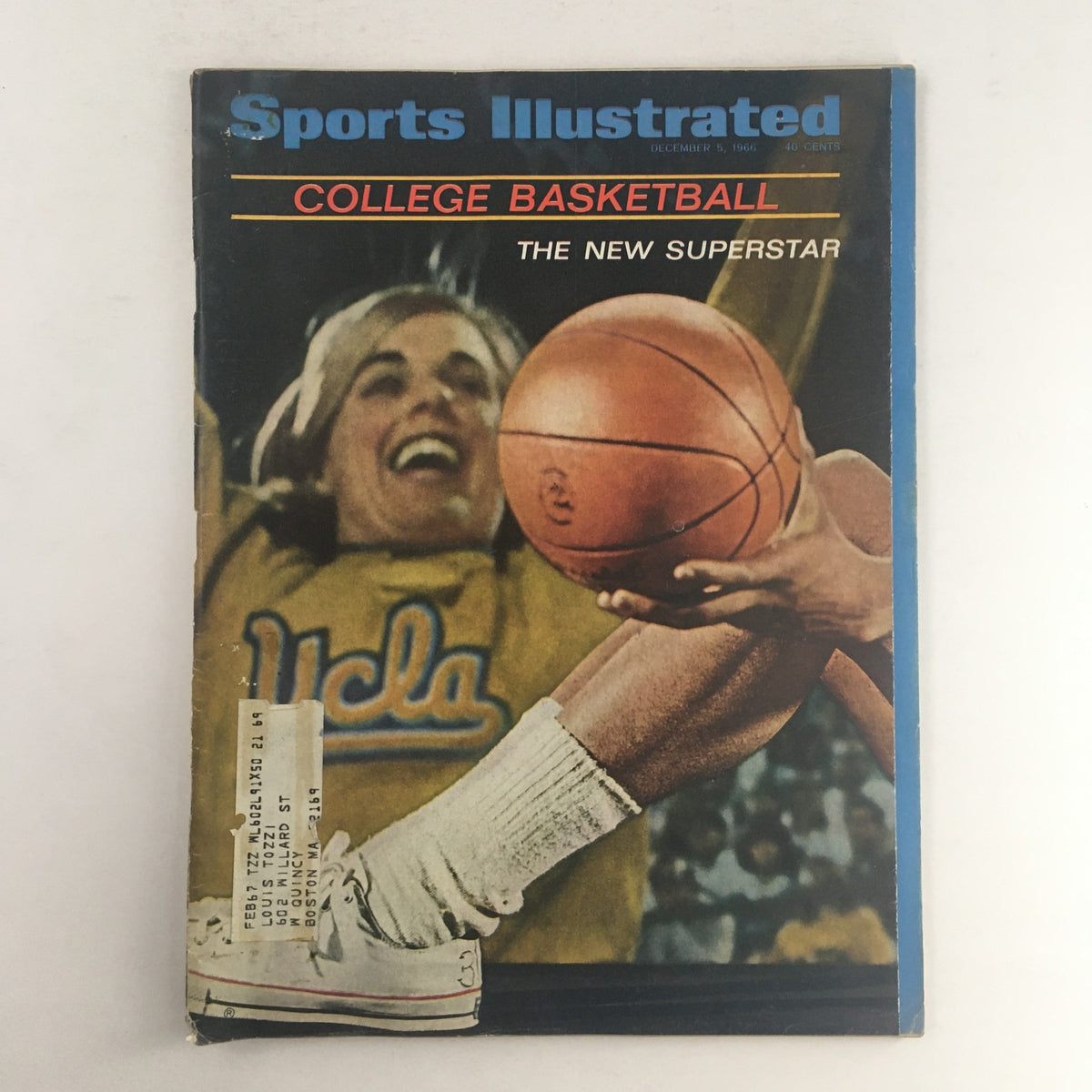 Cover of Sports Illustrated Magazine December 5 1966 featuring College Basketball and titled 'The New Superstar'. The image shows a player happily holding a basketball, wearing a UCLA jersey.