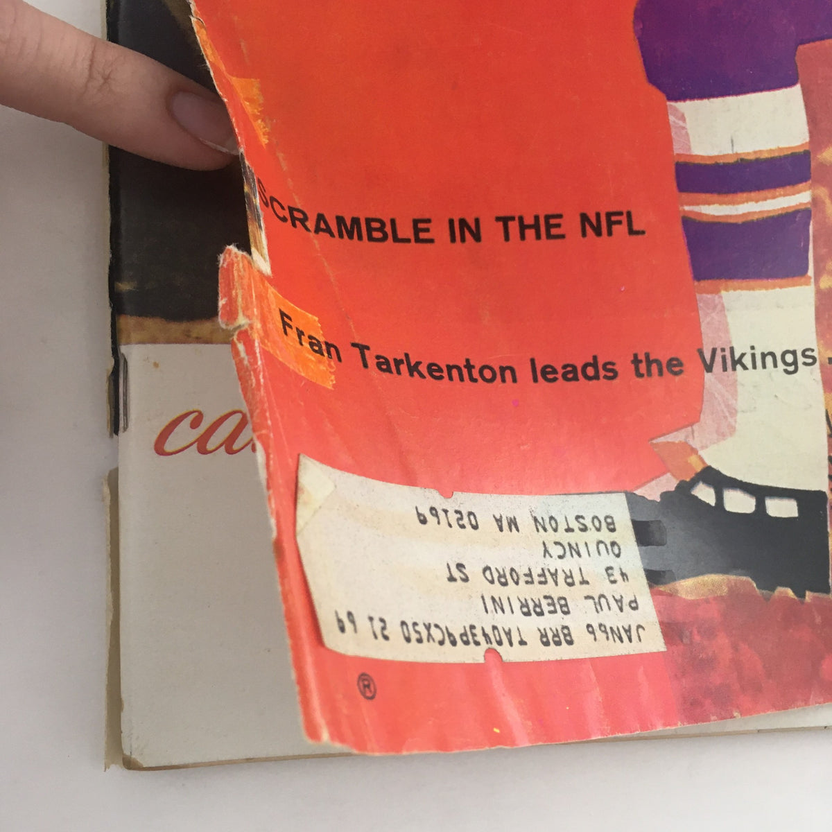 Close-up view of the Sports Illustrated Magazine cover from September 13, 1965, highlighting the text 'Fran Tarkenton leads the Vikings' and 'Scramble in the NFL.'