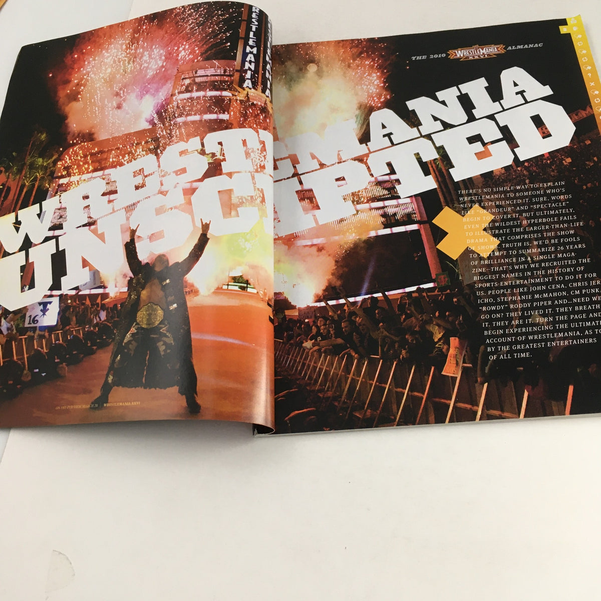 Inside spread of WWF Magazine 2010 showcasing the Wrestle Mania theme with a vibrant celebration image of the event, part of the Wrestle Mania XXVI Almanac.